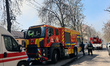 Firefighters walk past a fire engine during a response effort in Kharkiv, Ukraine, on Apri...