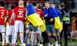 Shakhtar Donetsk player Valeriy Bondar holds the Ukrainian flag during the Conference Leag...