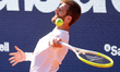 Corentin Moutet sends a ball into the stands during the match against Lorenzo Musetti in t...