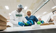 Former Green Bay Packers wide receiver Randall Cobb assists on the bakery production line...