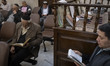 Iranian-Jewish men read prayer books as they participate in a prayer ceremony commemoratin...