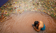 A Nepali Hindu devotee takes a dip in the sacred Mata Tirtha pond located in a hill statio...