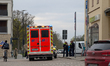 Emergency ambulance, first responder vehicle, and police officers stand near the railway s...