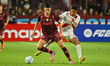 Yoshan Valois, a Lanus player, challenges for the ball with an Always Ready player during...