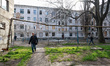 People walk past a hostel damaged by a Russian military operation in Odesa, Ukraine, on Ap...