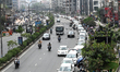 People wait in line to refuel their vehicles at a filling station during a fuel crisis in...