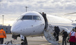 Passengers boarding in a Lufthansa CityLine Bombardier CRJ-900 passenger aircraft at Lyon–...