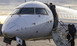 Passengers boarding in a Lufthansa CityLine Bombardier CRJ-900 passenger aircraft at Lyon–...