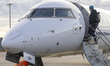 Passengers boarding in a Lufthansa CityLine Bombardier CRJ-900 passenger aircraft at Lyon–...