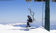 The chairlift transports people in the upper part of the mountain. Spring time skiing in G...