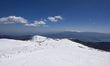 Panoramic view from the slopes of mountains and lakes. Spring time skiing in Greece. Skier...