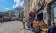 People sit at outdoor restaurant tables beside Viktualienmarkt in Munich, Germany, on Apri...