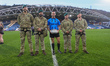 Referee Jack Smith, a former Royal Marine, poses with Royal Marines who deliver the match...