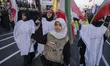 An Iranian schoolgirl holds a rifle as she marches in a military parade of Iran's self-sac...