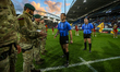 Royal Marines present the match ball to referee Jack Smith, a former Royal Marine, during...