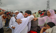A Kashmiri Hajj pilgrim is embraced by a relative before departing for the annual Hajj pil...