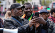 Shepherd Yuda and Makomborero Haruzvishe speak as UK-based Zimbabweans gather outside the...