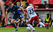 Ryley Towler of Lincoln City is challenged by Louis Thompson of Stevenage during the Sky B...