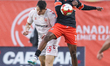 Forge FC striker Ismael Oketokoun (#7) competes with Cavalry FC defender Amer Didic (#55)...
