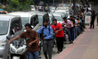 Long queues of customers are seen at fuel stations amid the ongoing fuel crisis in Dhaka,...