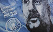 A mural of Pep Guardiola, manager of Manchester City, is seen on a fan's house near the Et...