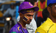 A fan wearing a Kolkata Knight Riders headband and sunglasses arrives ahead of an Indian P...