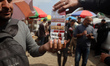 Palestinian vendors sell cigarettes at a tobacco market on Omar Al-Mukhtar Street in Gaza...