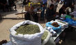 A Palestinian man displays dried molokhia leaves at the tobacco market on Omar Al-Mukhtar...