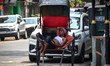 A hand-pulled rickshaw puller rests during a heatwave in Kolkata, India, on April 19, 2026...