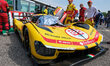 #83 Yifei Ye, Robert Kubica, and Philip Hanson of AF Corse, stand with their Ferrari 499P...