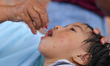 A Nepali child receives a Vitamin A capsule at an inoculation center in Kathmandu, Nepal,...