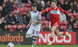 Charlie McNeill of Sheffield Wednesday runs with the ball as Tommy Conway of Middlesbrough...