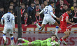 Murphy Cooper, Sheffield Wednesday goalkeeper, dives low to take the ball away from David...