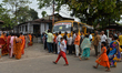Voters stand in a queue at a polling station to cast their ballots during the first phase...