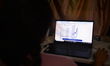 An employee in the insurance sector monitors market rates of currency, shares, and gold an...