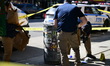 NYPD investigators collect evidence at the scene where one man is killed and another man i...