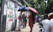 Women use umbrellas to shield themselves from the sun during a heatwave in Dhaka, Banglade...