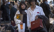 Iranian youths walk together along a sidewalk in downtown Tehran, Iran, on April 23, 2026,...