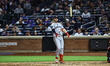 Minnesota Twins player Ryan Jeffers, number 27, flips his bat after hitting a grand slam d...