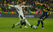 Malcom Braida, a Boca Juniors player, contests the ball with a Defensa y Justicia player d...