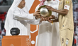 Al Rayyan SC captain Abdulaziz Hatim (right) receives the trophy after winning the AGCFF G...
