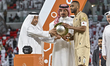 Al Rayyan SC captain Abdulaziz Hatim (right) receives the trophy after winning the AGCFF G...