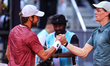 Jannik Sinner of Italy shakes hands with Benjamin Bonzi of France in a multiple exposure d...