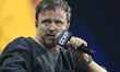 Aaron Paul speaks during a conference as part of the pop culture festival CCXP 'Comic Con...