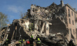 Rescuers search for survivors under the rubble of a four-storey apartment block in Dnipro,...