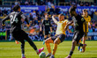 Joao Gomes of Wolverhampton Wanderers is tackled by Djed Spence and Yves Bissouma of Totte...