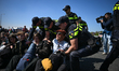 Police carry out numerous arrests following a protest that blocks a major roadway near De...