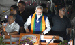 Indian Prime Minister Narendra Modi greets supporters during a roadshow ahead of the secon...