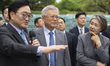 Former South Korean President Moon Jae-in (center) and former First Lady Kim Jung-sook lis...