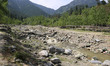 Indian army soldiers walk on a wooden bridge in Baramulla District, North Kashmir, on Apri...